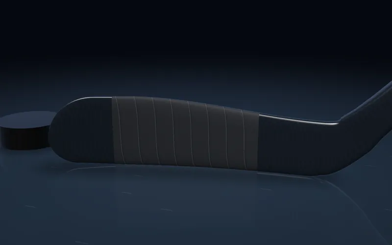A hockey blade with a light mid-blade tape job, the kind many young players start with.